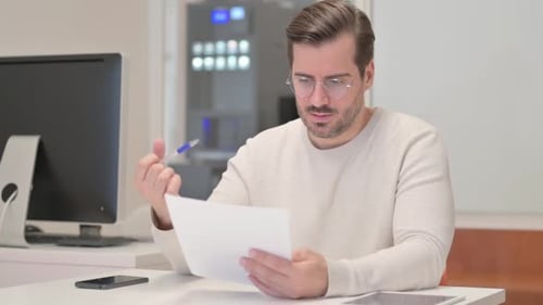 Middle Aged Man with Loss on Tablet in Office