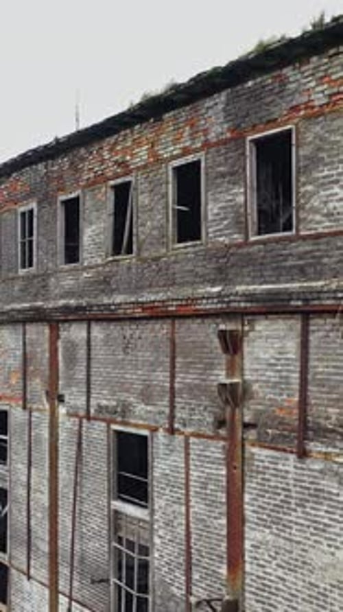 Ruins of an old factory. Old industrial complex. Aerial view. Vertical video
