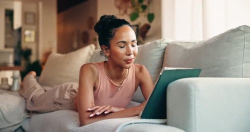 Relaxed Woman Using Tablet Device Lying on Couch