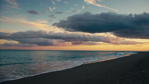 Calm Waves of Ocean Crashing on the Beach with Beautiful Sunset Sky