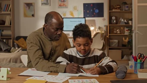 Mature African American Father Homeschooling Young Son