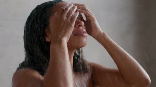Woman Washing Long Braided Hair in Shower