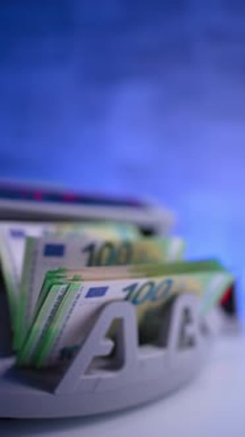 Green euro banknotes of one hundred par counted in machine. Financial operations in the bank.