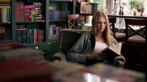 Young Woman Reading Book in Library
