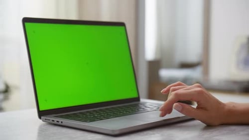 Hand Browsing on Laptop Green Screen in Reveal Shot
