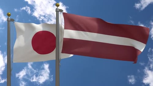 Realistic Waving Japan and Latvia Flags Against Blue Sky