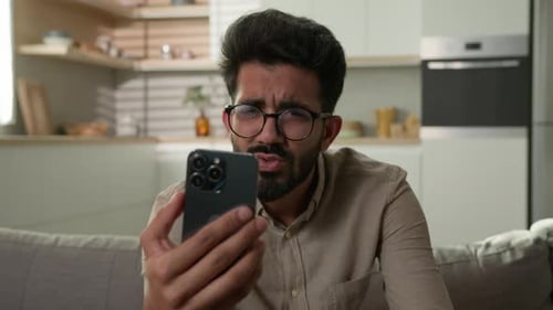 Young Adult Video Chatting Frustrated at Home