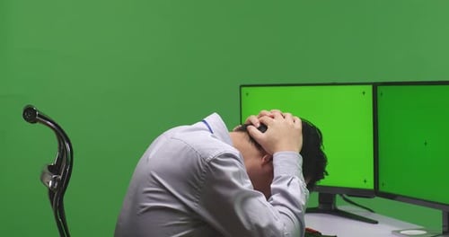 Man Having Headache While Working With Mock Up Multiple Monitor In Green Screen Studio