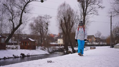 Girl Jumps and Walks in the Winter Snow