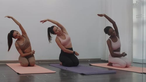 Multicultural Group of Women Performing Side Bends at Stretching Class