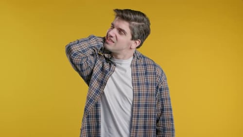 Young Adult Man with Neck Pain Expression