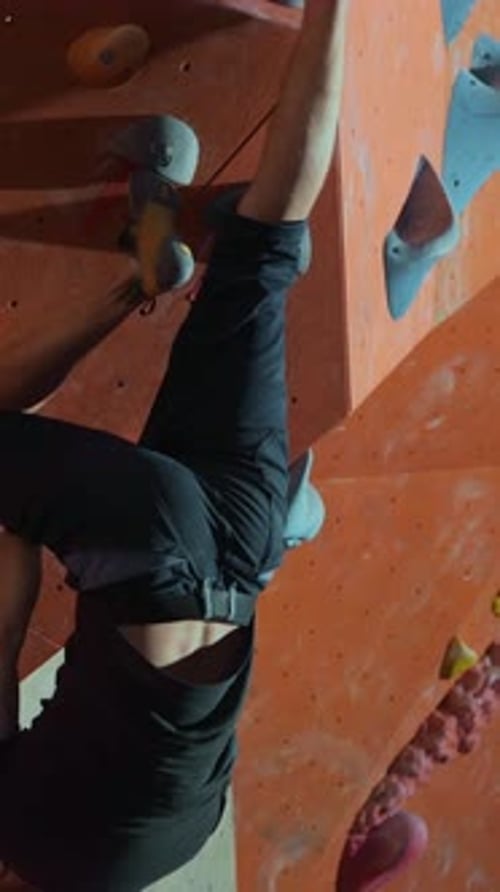 Man rock climbing on indoor rock wall