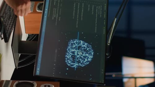 Computer Monitor Displaying AI Brain Visualization and Code