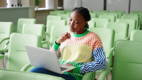 African American Female Student Working in an Empty Conference Room