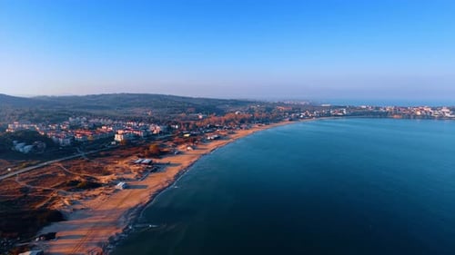 Blue waterscape with sandy beaches. Aerial perspective on the city located at the sea coast.