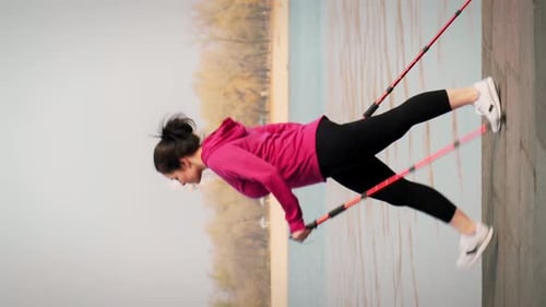 Nordic walking. Fit chubby woman with nordic walking poles