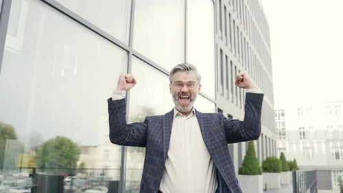 Excited Business Man Celebrates Success Outdoors