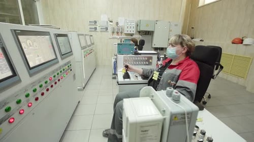An Operator is Actively Engaged in Work Within a Control Room Environment to Ensure Efficiency Stock