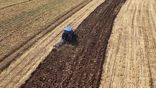 Aerial View Of Tractor Working In Farmland