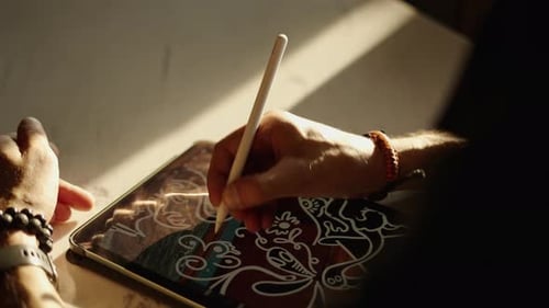 Artist Drawing Abstract Design on Tablet Device