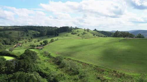 Beautiful aerial scenic panoramic view of rolling countryside green farm fields and forests