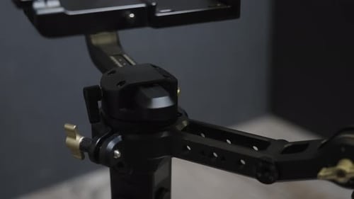 The arm of a stabilizer being rotated in camera.