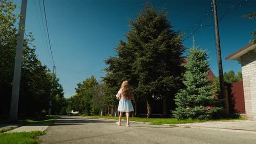 Kid Walking Home Through Calm Residential Street on Sunny Day