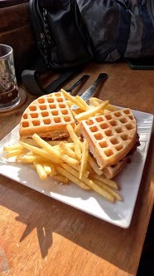 Waffle Sandwich with Fries on a Wood Table