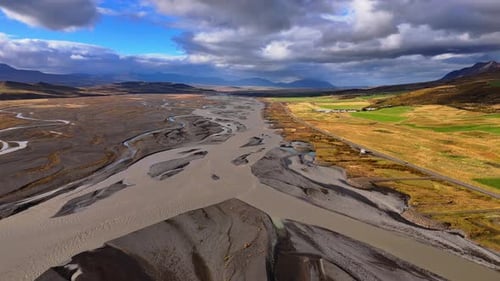 River braids reaching into the highlands. Dramatic valley aerial, Iceland.
