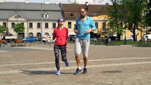 Couple of Joggers Resting After Jogging in the City Active