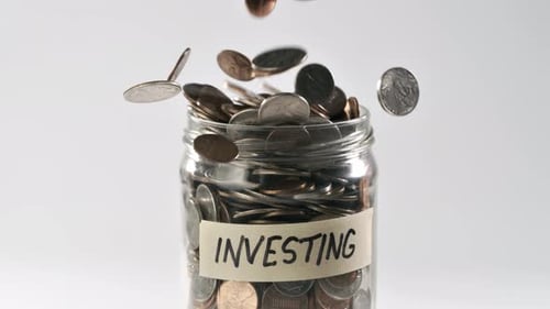 Jar Labeled Investing Filled with Coins