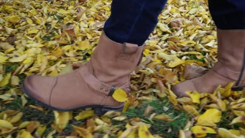 Woman Feet Walks in Autumn Park