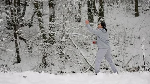 Man Doing Martial Arts in Snowy Winter Forest