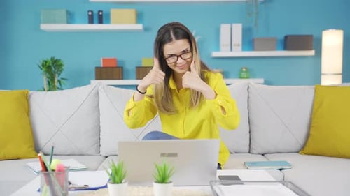 Woman Working on Laptop Gives Thumbs Up
