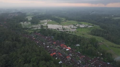 Aerial view of rice fields and village at sunset, Bali, Indonesia.