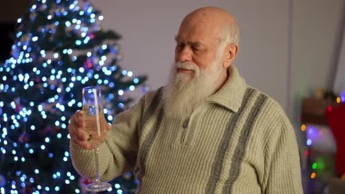 Senior Man Celebrating Christmas with Champagne