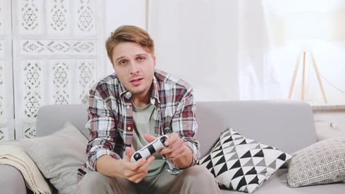 Young Man Playing Video Games on Couch