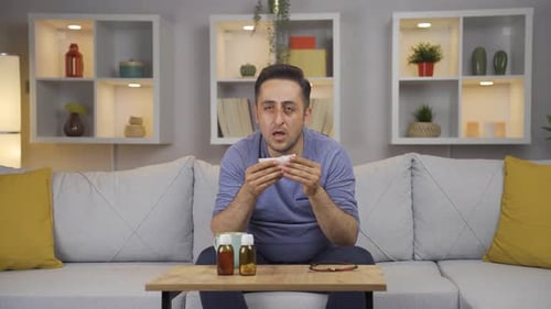 Man covering his mouth and nose while coughing.