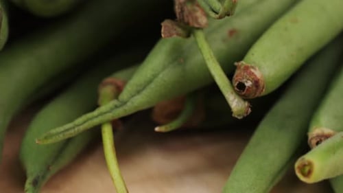A Pile of Fresh Green Beans a Staple Food Ingredient Rests on a Wooden Cutting Board These Natural