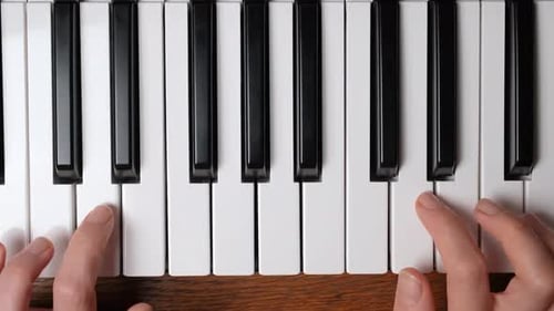 Close Up View on the Hands of a Beginner Pianist Playing the Piano