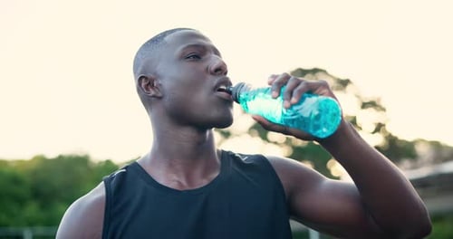 Athletic Young Man Drinking Water Outdoors