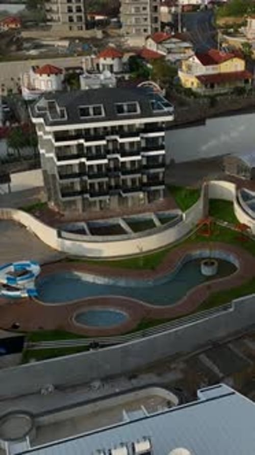 Aerial Footage of High-Rise Building With Pool