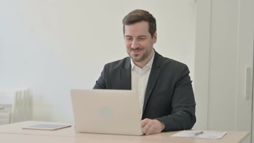 Man in Suit Video Calling from Office Space