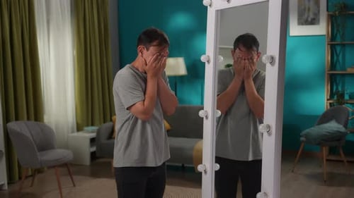 Exhausted Man Looking at His Reflection in Mirror Standing in Living Room Apathy Inner Conflict