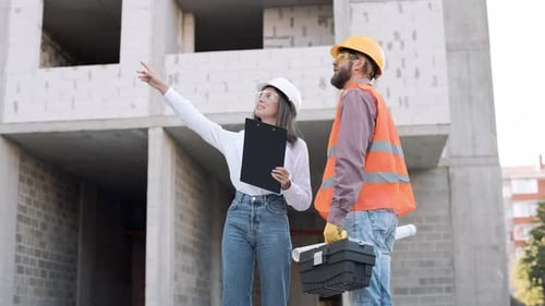 Construction team collaborates on building site progress in urban setting during daytime hours