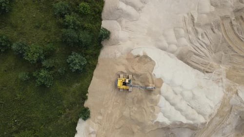 Aerial Top Down View on Excavator is Working in a Sand Quarry