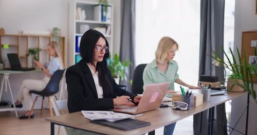 Office Workers Engaged and Focused on Tasks