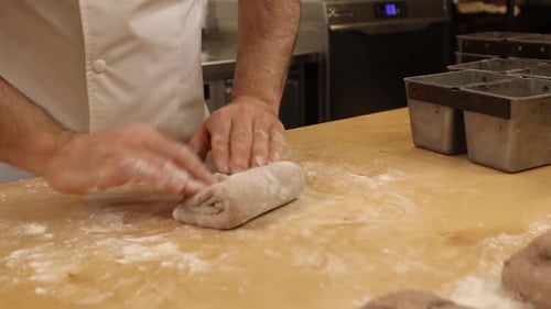 a chef makes bread in a bakery