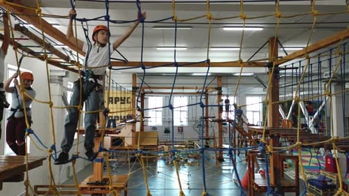 Children Traverse Challenging Indoor Rope and Obstacle Course