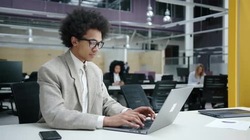 Closeup View of a Serious Entrepreneur Typing on a Laptop